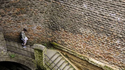 Man walking down stone stairs in The Park, Nottingham. Stock Footage 129883909