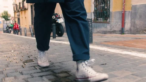 Man walking down stone street in Spain Stock Footage 255863797