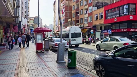 A man walking down a street with boxes on the sidewalk Video stock 272911872
