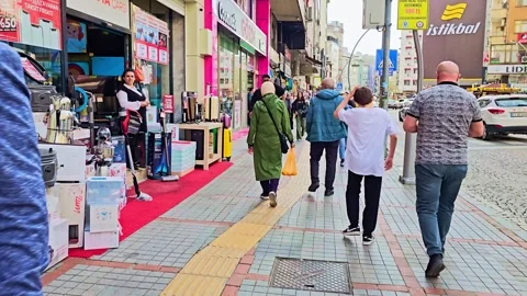 A man walking down a street with a car Stock Footage 272906648