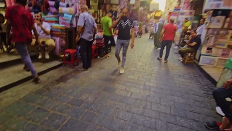 A man walking down a street in a crowded market Stock Footage 292190942
