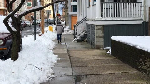 A man walking down a street in New Brunswick, NJ Stock Footage 87626031