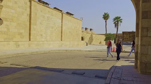 A man walking down a street next to a wall Stock Footage 291594832