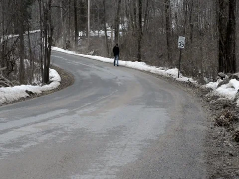 Man Walking Down Winter Road Stock Footage 34328743