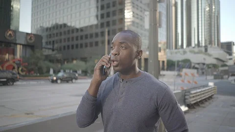 Man walking in downtown while on his phone Video stock 98908441