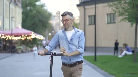 Man walking with e scooter at the street. Stock Footage 139330947