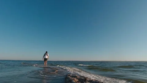 The man is walking on the edge of the Kinburn Spit early morning, Ukraine Stock Footage 276358881