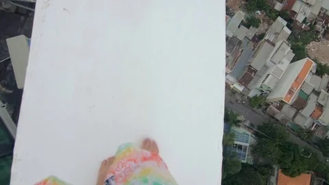 Man walking on the edge of a tall building close-up Stock Footage 73352852