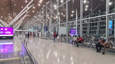 A man walking up the elevator inside the modern airport Stockbeeldmateriaal 239779944