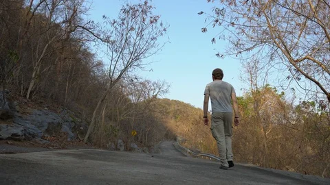 Man Walking on Empty Abandoned Road in Mountains - Coronavirus Pandemic Escape Stock Footage 127941965