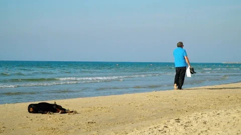 Man Walking On An Empty Beach Stock Footage 120647530