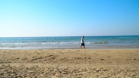 Man Walking On An Empty Beach Video stock 120647749