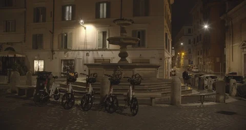 A man walking in an empty city square by night Stock Footage 127584056