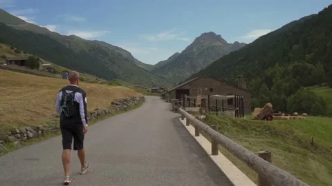 Man walking on the empty mountain road Video stock 158631774