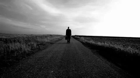 Man walking on the empty road Stock Footage 34884619