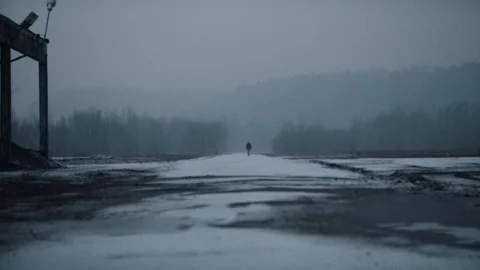 Man walking on an empty road in winter. Stock Footage 88432532