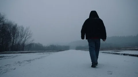 Man walking on an empty road in winter. Stock Footage 88432598
