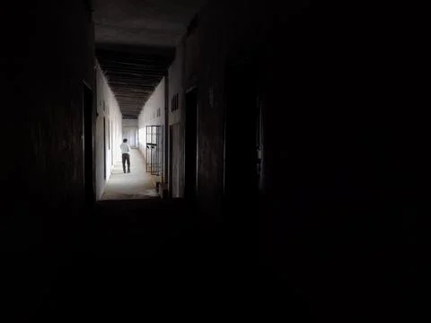 A man walking in Empty Walkway in an old school corridor in an Indian village Stock Photos