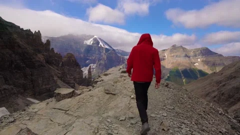Man Walking On Epic Mountain Peak Video stock 230092070