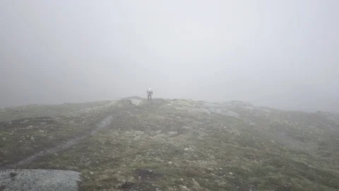 Man walking in epic norwegian mountain fog 2 Stock Footage 89648145