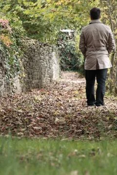 Man walking on fallen leafs Stock Photos