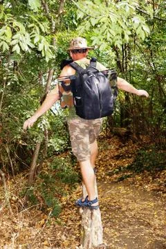 A man walking on a fallen tree Stock Photos