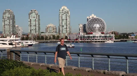 Man walking at False Creek Stock Footage 30687517