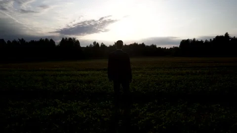 Man walking in the field part2 Видео 142318203