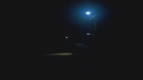 The man walking with a flashlight on the street. night time. anamorphic shot Stock Footage 80680849