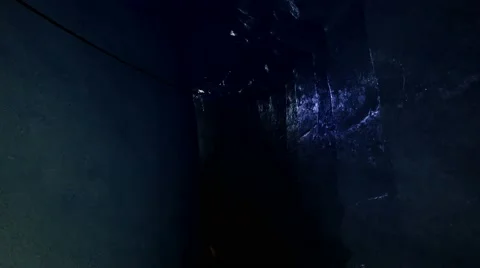 Man walking with flashlight though dark ice cave. melting ice Stock-Footage 64799618