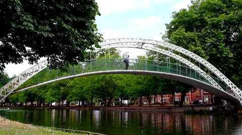 Man walking on foot bridge over river Stock Footage 45842090