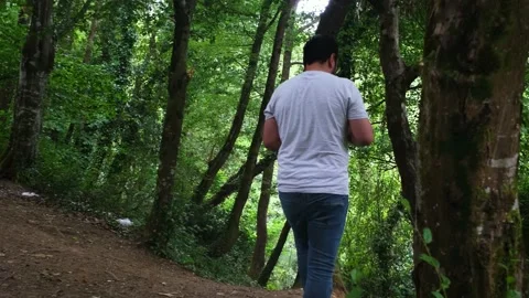 Man walking in the forest slowmotion Stock Footage 237746176