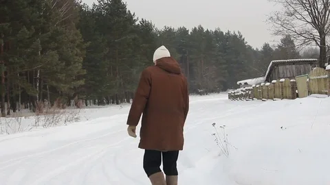 A man walking on a forest track in snow Video stock 82192330