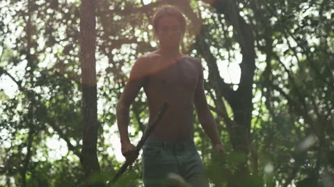Man walking in a forest without a shirt Stock Footage 279853801