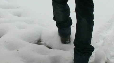 Man walking on fresh snow Stock Footage 14400634