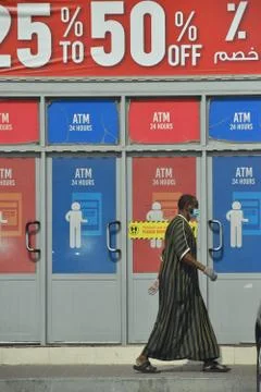 Man walking in the front of atm counter.Editorial. Stock Photos