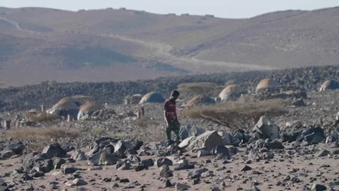 Man Walking in Front Of Nomadic Village in Eastern Africa Vídeos de archivo 144983828