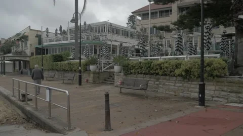 Man Walking In Front Of Watsons Bay Boutique Hotel - Watsons Bay Beach Stock Footage 142324153