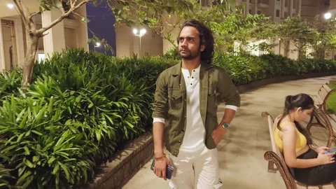 Man walking in garden in serious expression Stock Footage 276775686