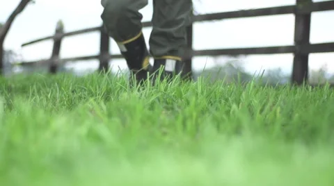 Man walking on grass. slow motion Stock Footage 65385026