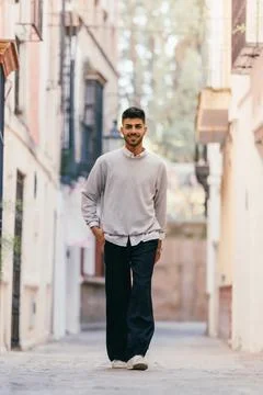 Man walking happily down a cobblestone street Stock Photos