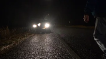 A man walking to his car at night in the rain Stock Footage 85883944