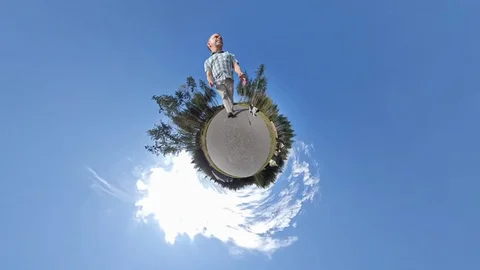 Man walking his dog on a tiny planet Stock Footage 115518495