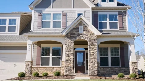 Man walking up to his front door and walking inside his generic suburban house Stockbeeldmateriaal 79445680