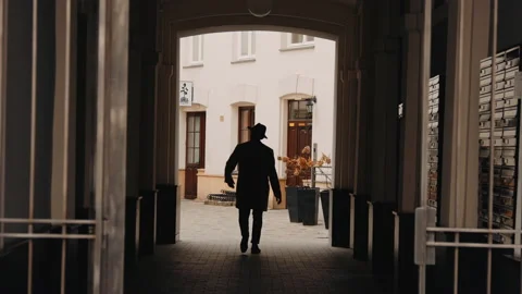 Man walking home an throwing the hat Stock Footage 166152718