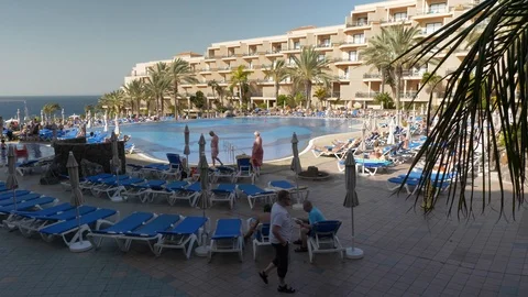 Man Walking At Hotel Pool With Sunbeds La Caleta Tenerife Spain Slow Motion Stock Footage 104397111