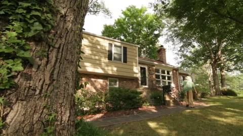 Man walking up to house Stock Footage 53002257