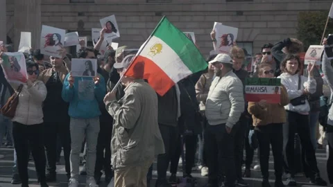 Man walking with Imperial State of Iran flag at protesting against current 스톡 동영상 217899975