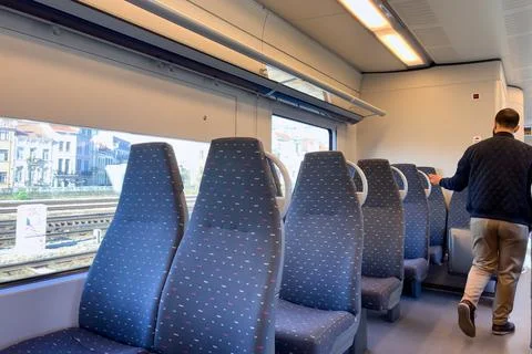 Man walking inside an emtpy  train in Belgium Stock Photos