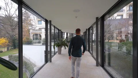 Man walking inside a glass walls at a ho... | Stock Video | Pond5